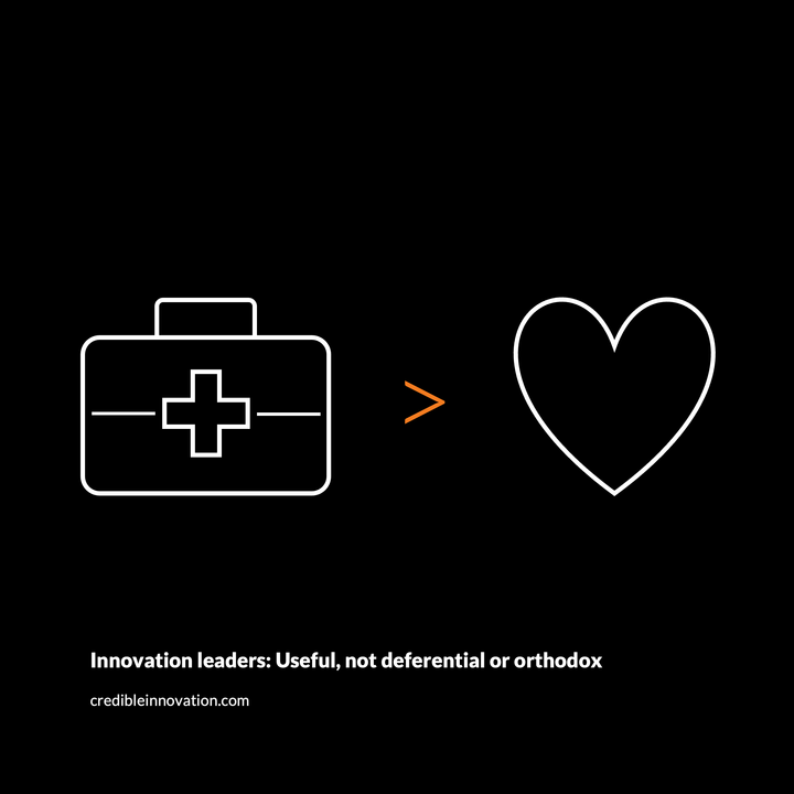 Icons on black background: A white first aid kit at left, an orange "greater than" symbol at center, and a heart at right